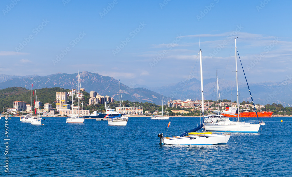 Sailing yachts and pleasure motorboats moored