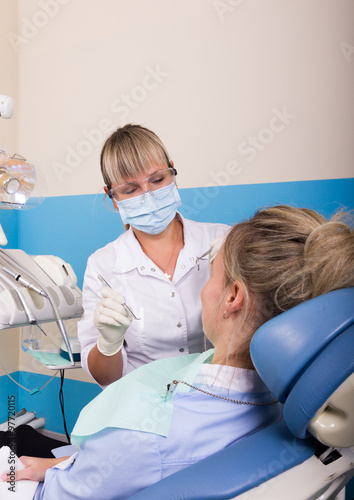 dentist examines the patient's mouth. the patient is ready for treatment teeth