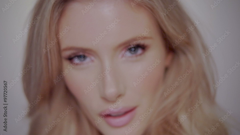 woman moving her hair for the slow motion video, perfect face with blue eyes and full pink lips woman moving her hair for the slow motion video, perfect face with blue eyes and full pink lips