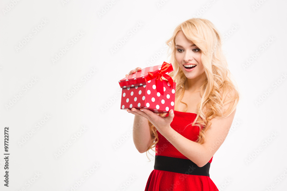 Happy excited young blonde female in red dress opened present Happy excited young blonde female in red dress opened present