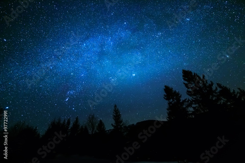 Milky Way in sky full of stars. Winter mountain landscape in night.