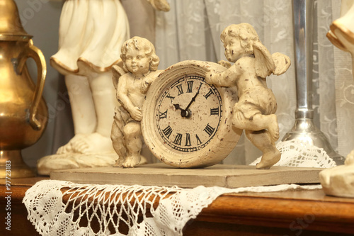 antique clock with two figures of angels