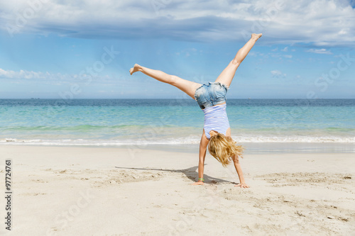 Young woman jumping on beach