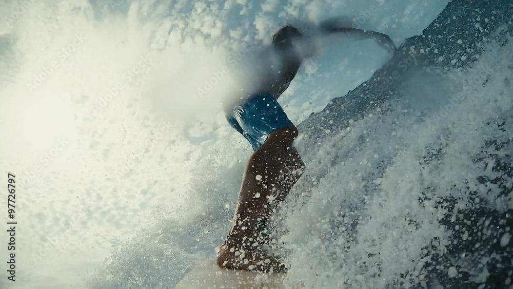 Surfer on Blue Ocean Wave in the Tube Getting Barreled
