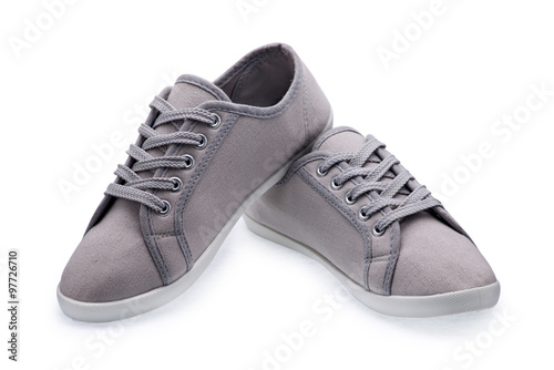 A pair of gray gumshoes with shoelace