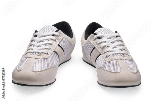 A pair of white sports shoes with shoelace