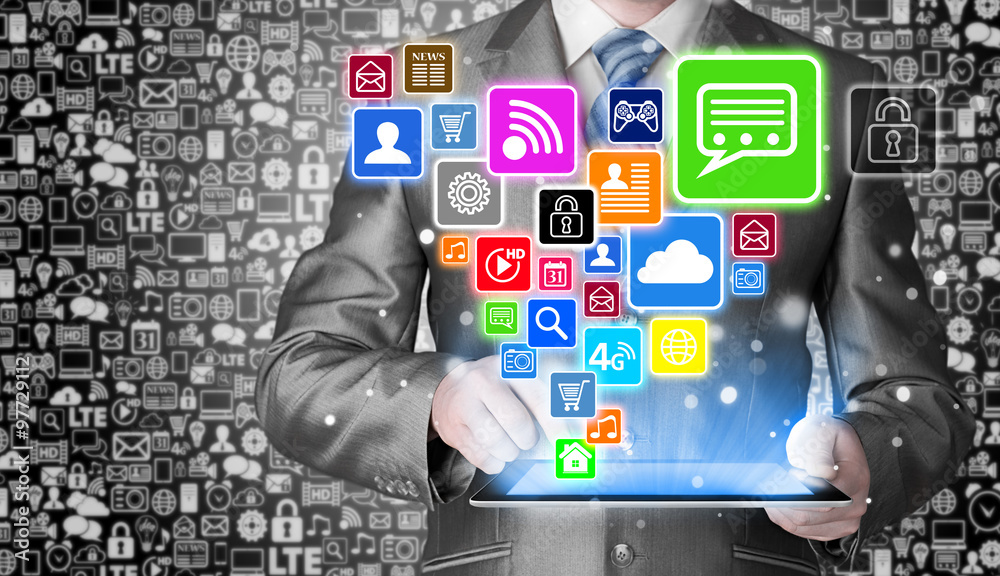 Obraz premium Business man using tablet PC with social media icon set