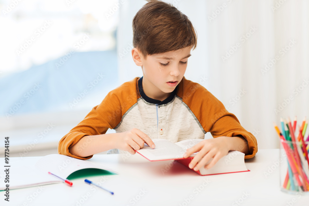student boy reading book or textbook at home student boy reading book or textbook at home