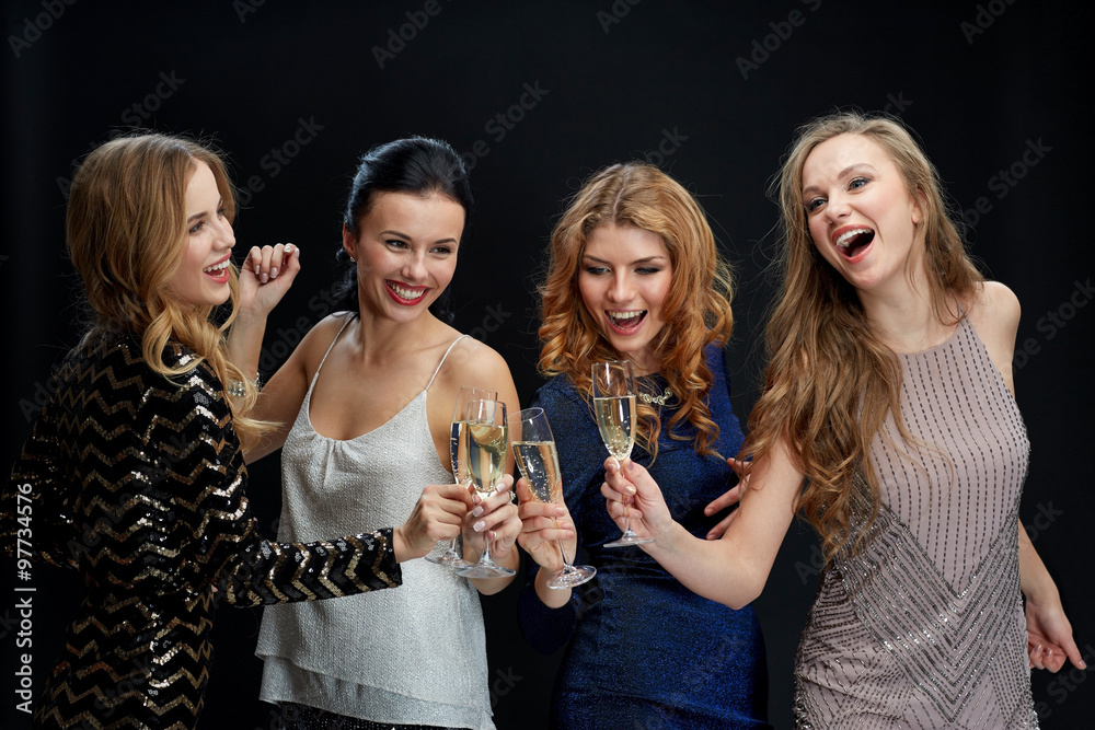 happy women clinking champagne glasses over black happy women clinking champagne glasses over black