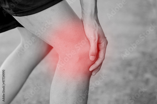Runner touching painful knee. Athlete runner training accident. Sport running knee sprain. © twinsterphoto