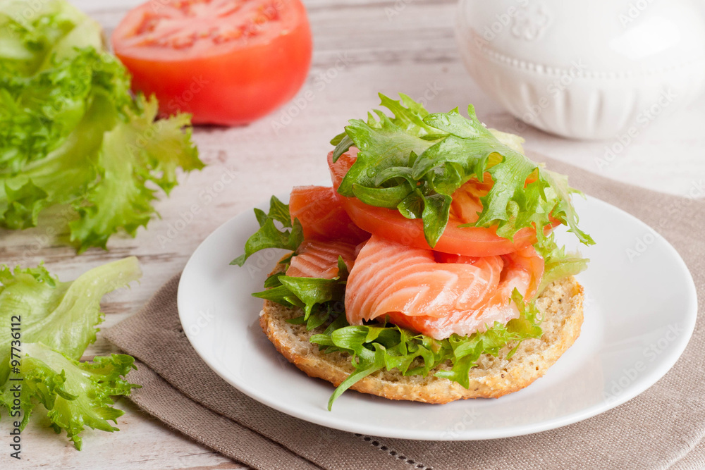 bun with cottage cheese, herbs, tomato and salmon