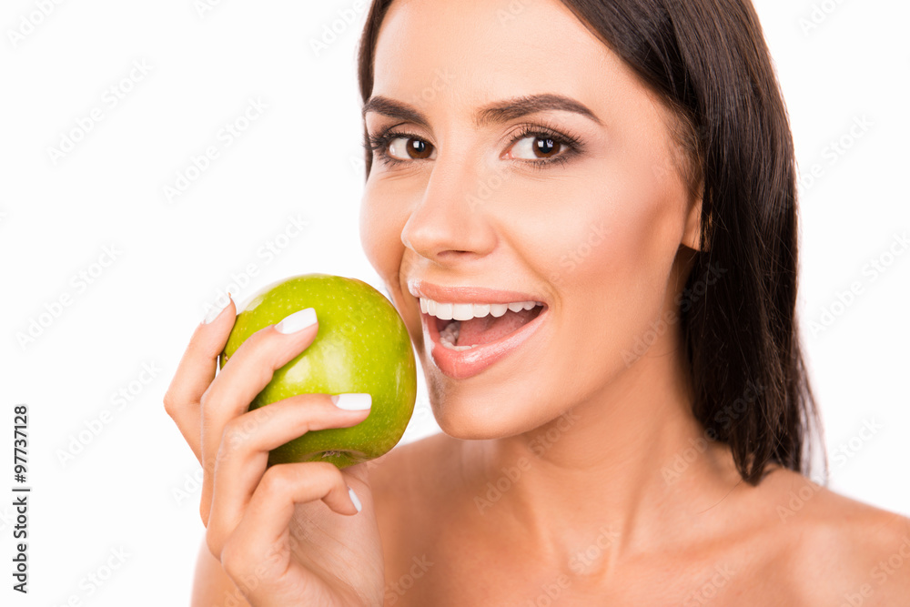 Beautiful healthy toothy girl biting green apple Beautiful healthy toothy girl biting green apple