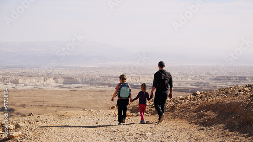 father traveling with two kids