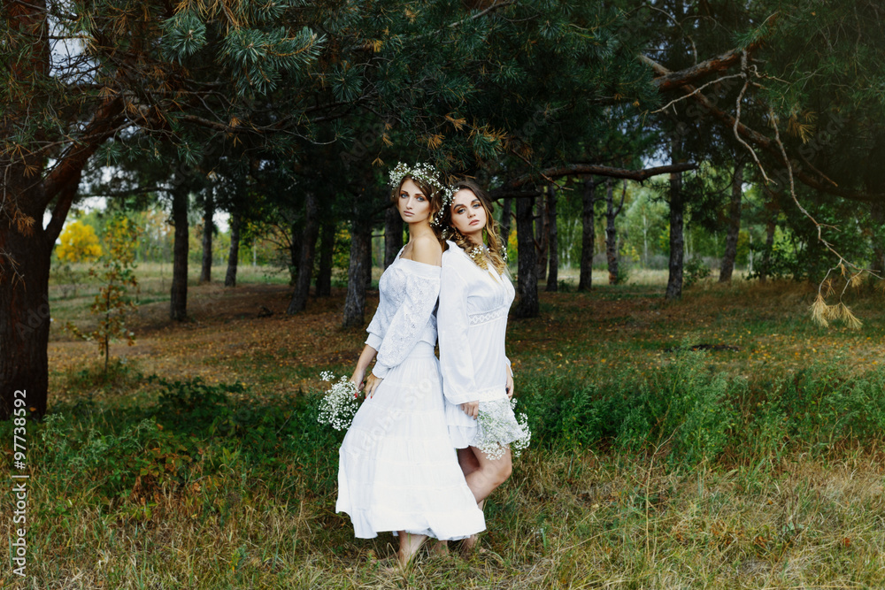 Two women in white dresses