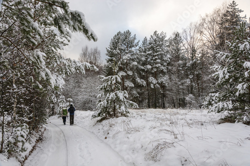 Tourists in a snowy forest.