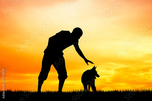 man with dog at sunset