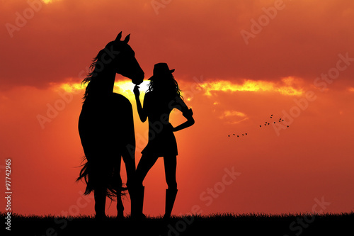 girl and horse silhouette at sunset