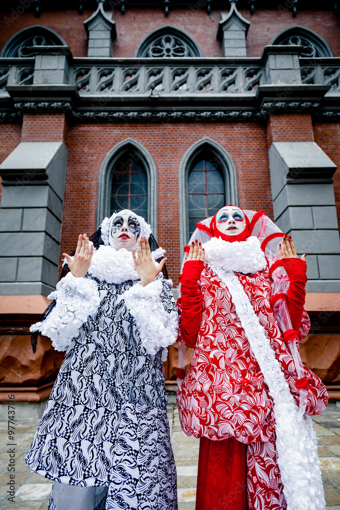 Obraz premium Two cheerful female clowns dressed in black and white cloth 