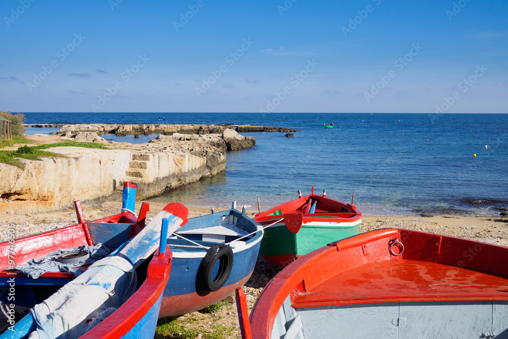 Small fishing boats docked in the harbor of Polignano a Mare - Apulia, Italy