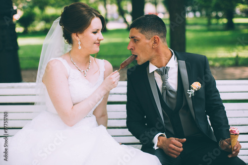 Bride and groom having an ice cream in outdoor