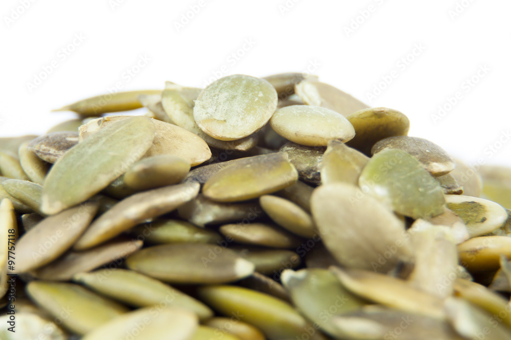 Closeup View of Pumpkin Seeds on a Plain Background Closeup View of Pumpkin Seeds on a Plain Background