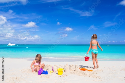 Little girls playing with beach toys during tropical vacation