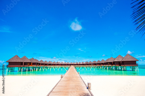 Water bungalows and wooden jetty on tropical island in Indian Ocean