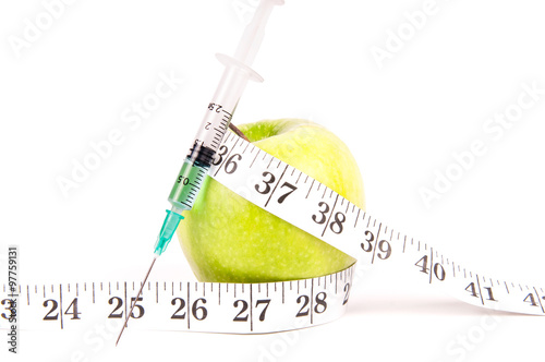 Syringe with apple and measuring tape