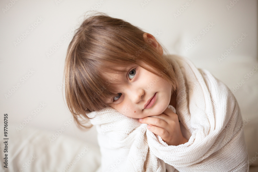 girl wrapped in a light blanket, light background girl wrapped in a light blanket, light background