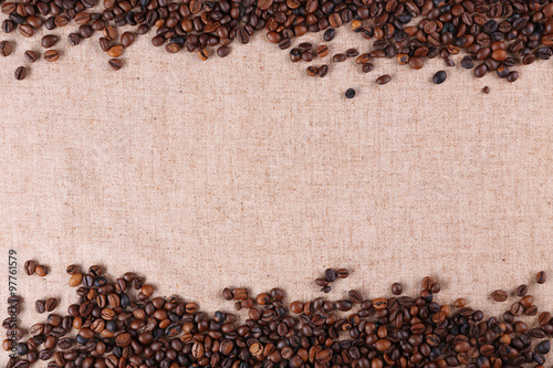 Frame of roasted coffee beans on the linen fabric