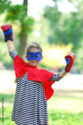 Little girl dressed as supe...