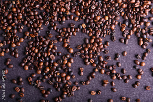 Roasted coffee beans on grey textile background