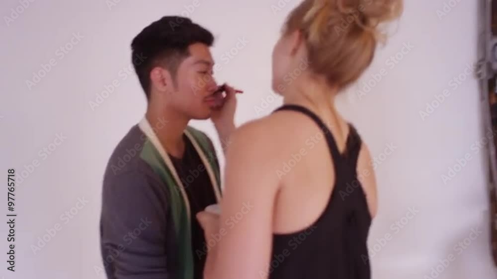 Stylist doing make up between shots at professional photo shoot studio Stylist doing make up between shots at professional photo shoot studio