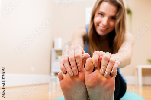 Happy young woman stretching