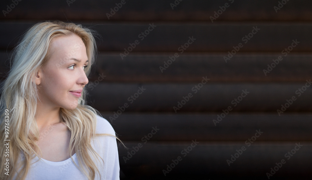 Attractive woman standing in front the rustic wooden door