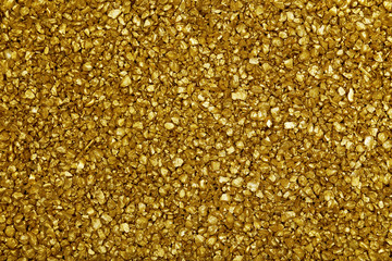 Gold nugget grains background, close-up