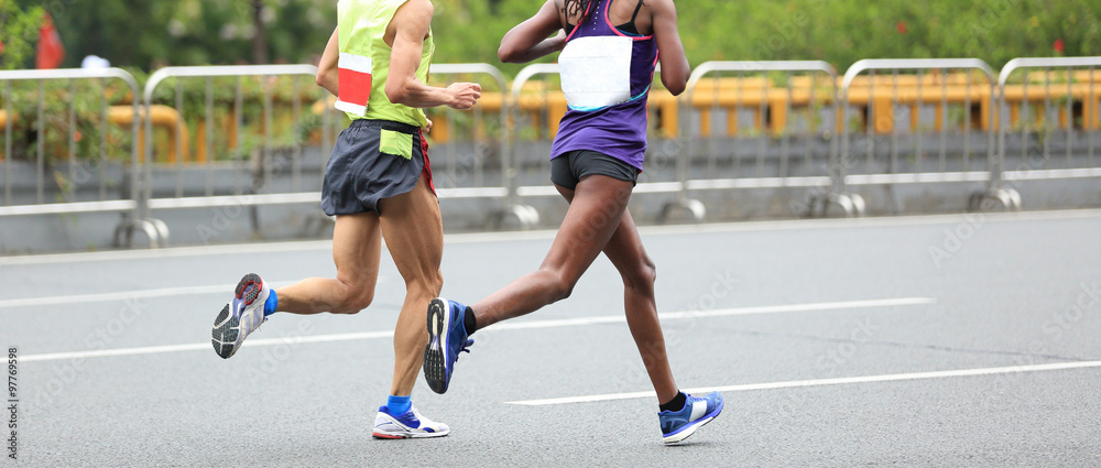 Marathon runners running on city road