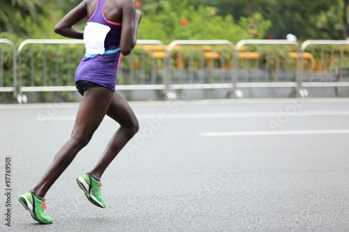 Marathon runner running on city road