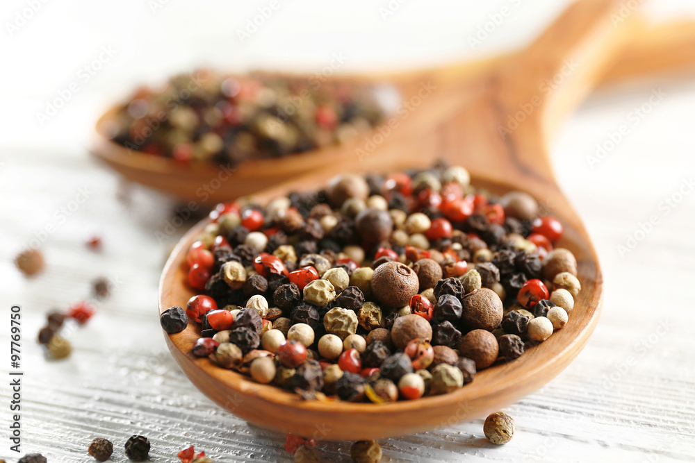Two wooden spoons with pepper on the table, close-up Two wooden spoons with pepper on the table, close-up