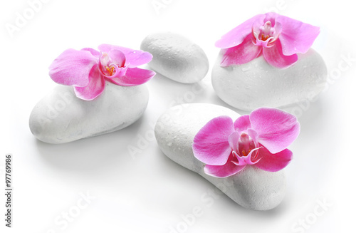 White spa stones and orchids isolated on white