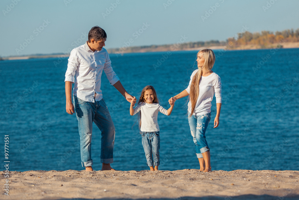 Happy family who playing on the beach. Concept of friendly familys Happy family who playing on the beach. Concept of friendly familys