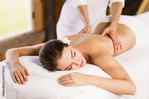 Woman enjoying massage. Fototapeta