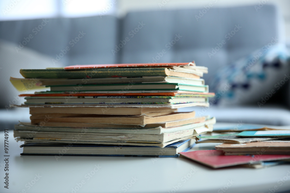 Pile of old books on white table in the room Pile of old books on white table in the room