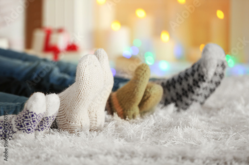 Legs in colorful socks on white carpet background