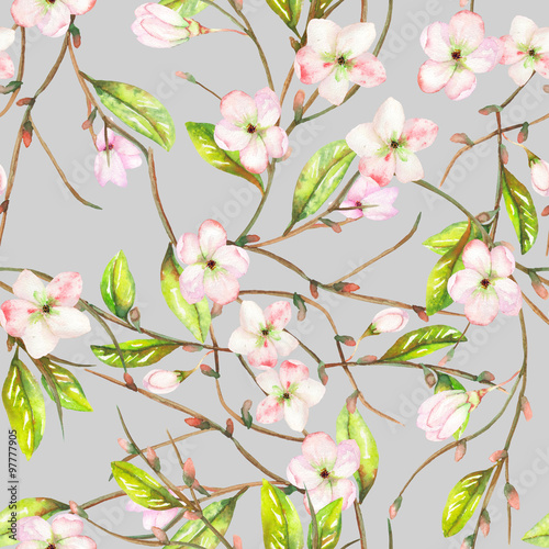 A seamless floral pattern with an ornament of an apple tree branch with the tender pink blooming flowers and green leaves  painted in a watercolor on a grey background