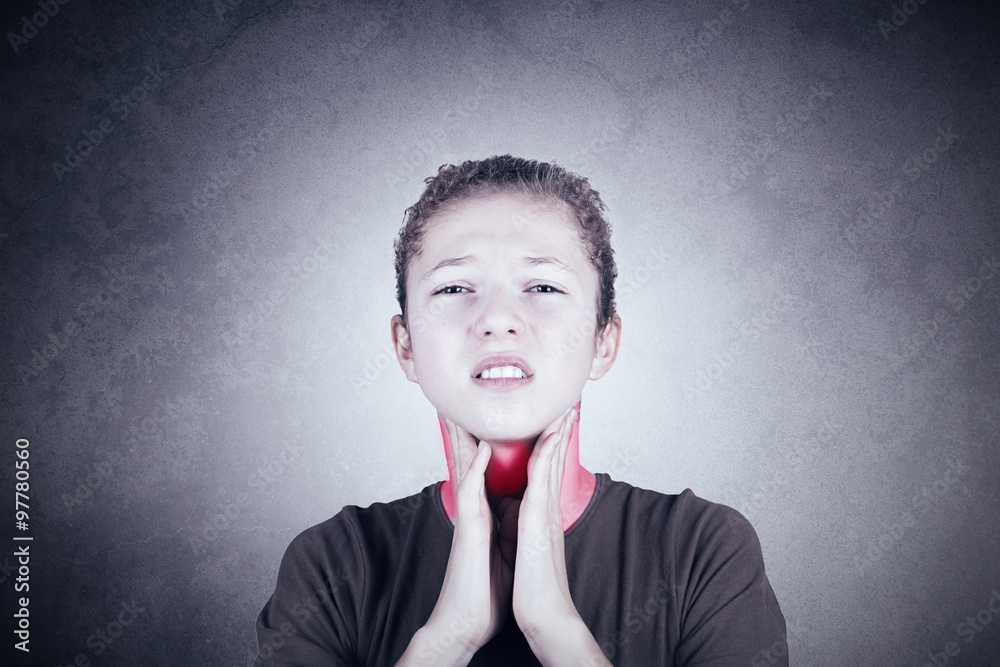 Little girl with sore throat touching her neck.Sore throat sick.Little