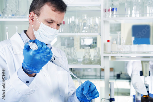 Male researcher at his workplace in the laboratory. photo