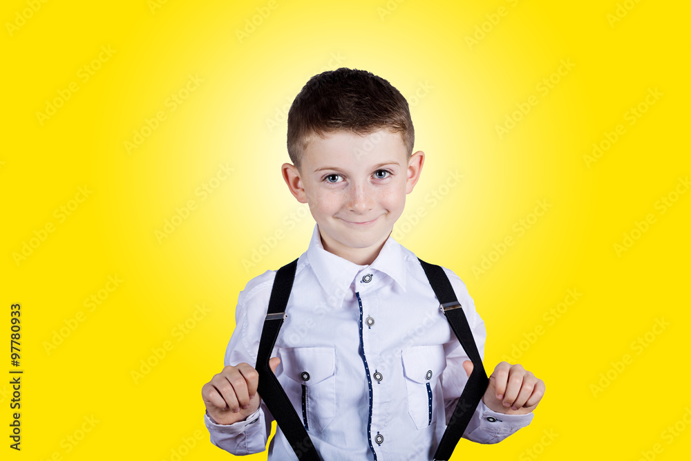 Smiling little boy holding his braces.Happy little boy over white background.Smiling, Happy, Joyful beautiful little boy , looking at camera. Smiling little boy holding his braces.Happy little boy over white background.Smiling, Happy, Joyful beautiful little boy , looking at camera.