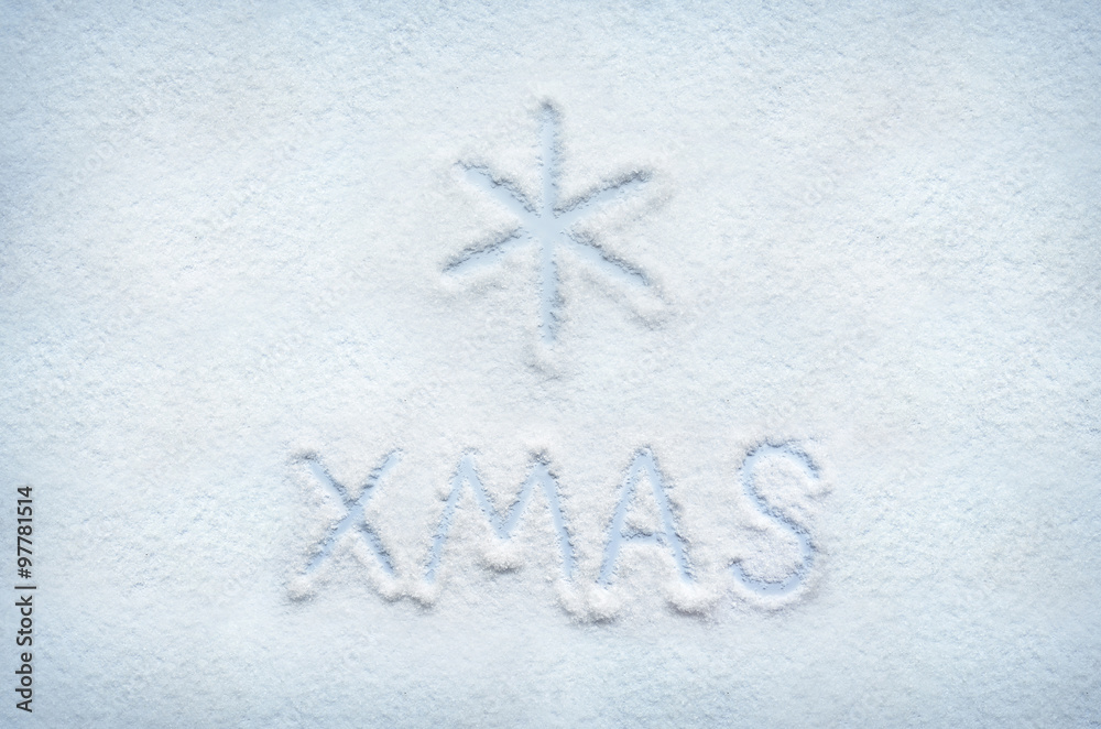 Text XMAS written on snow and snowflake sign mark. Horizontal postcard. Text XMAS written on snow and snowflake sign mark. Horizontal postcard.