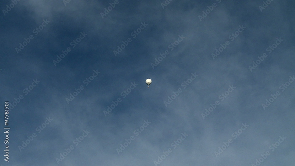 White hot air balloon floating in sky White hot air balloon floating in sky